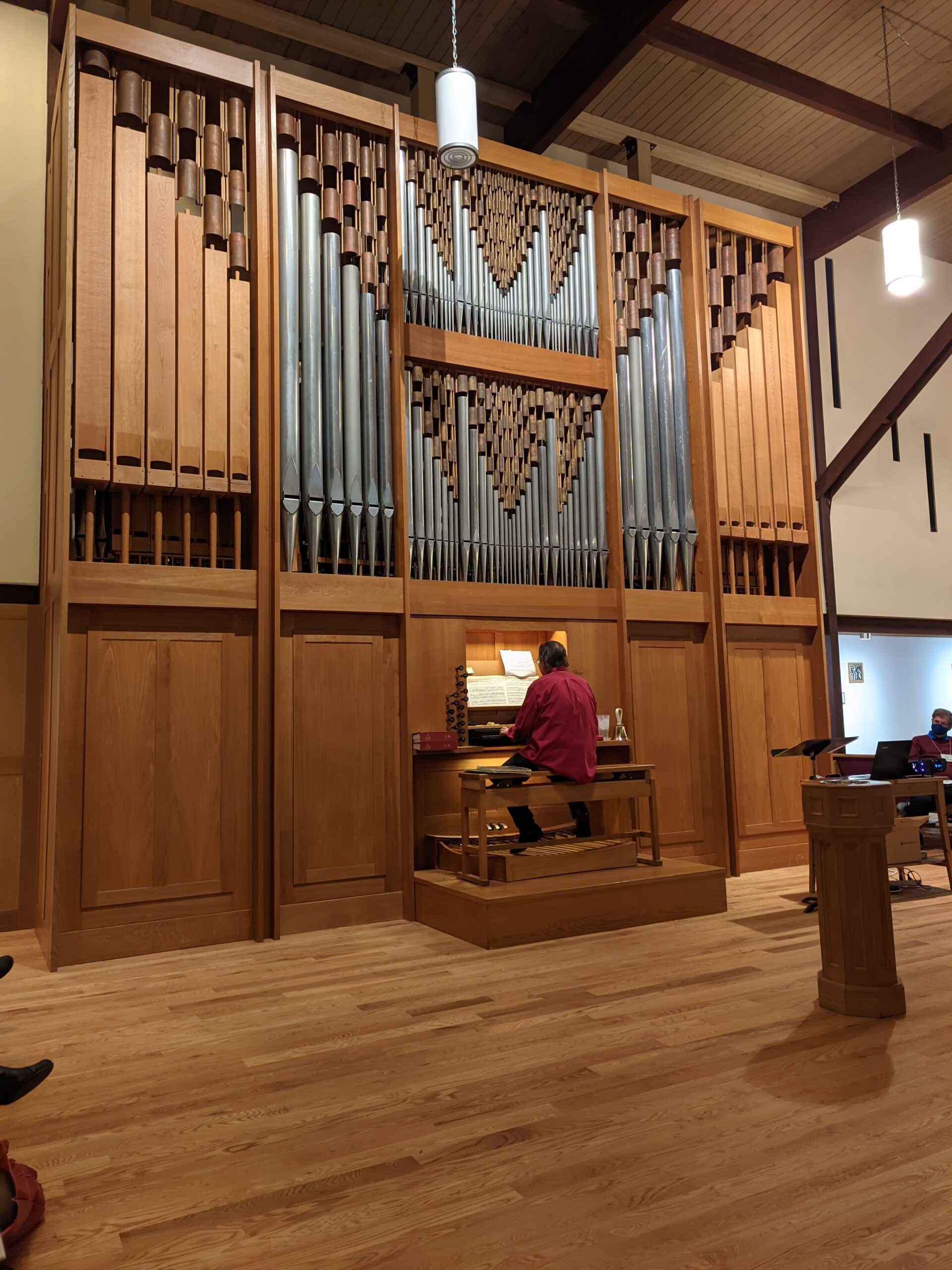 Close view of the Rieger/Pasi organ with Dennis Northway sitting on the bench