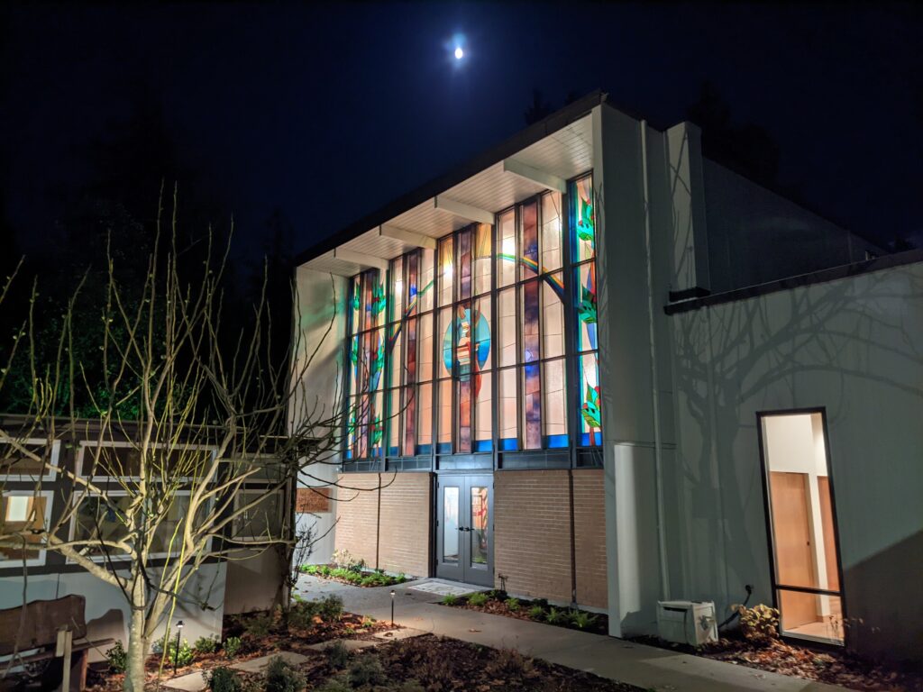 night view of Saint John's Episcopal Church, Gig Harbor, WA, showing a stained glass window