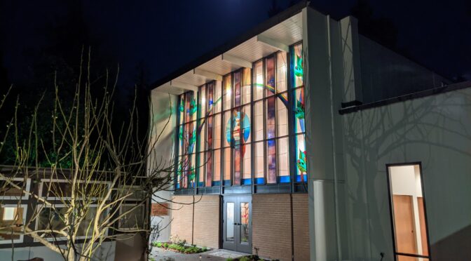 night view of Saint John's Episcopal Church, Gig Harbor, WA, showing a stained glass window