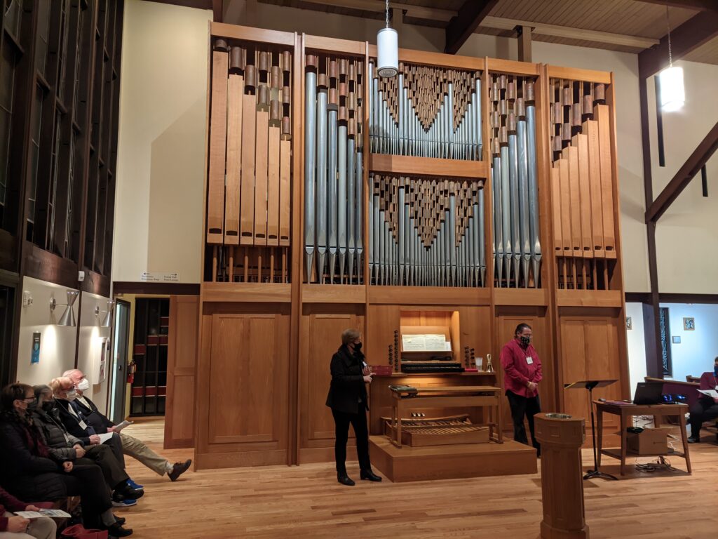 Sheila Bristow and Dennis Northway standing in front of the organ