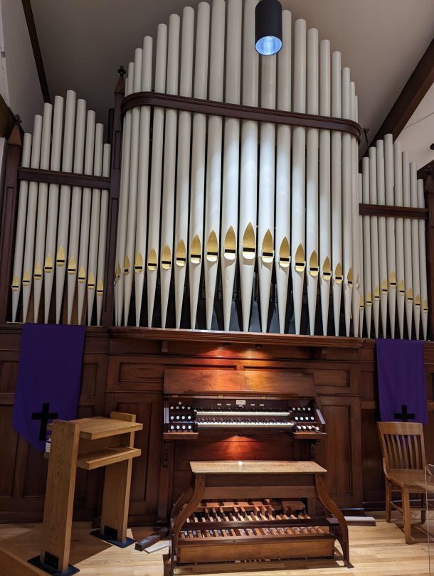 Organ with pipes, key desk, and pedal board