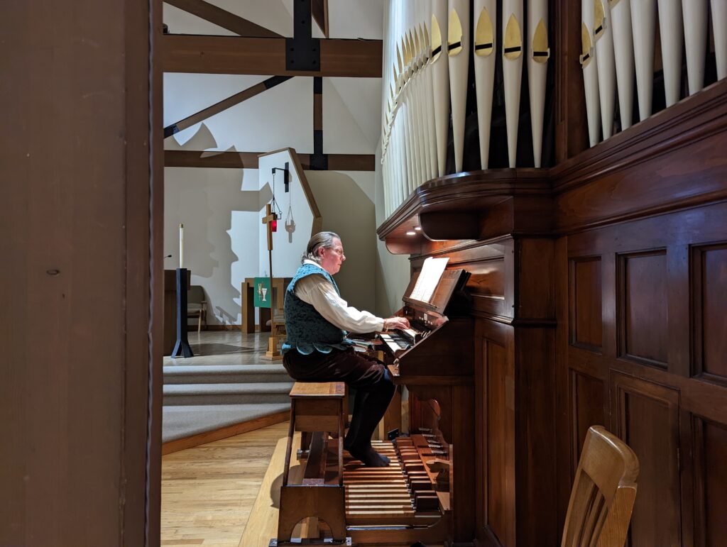 Man in costume playing organ
