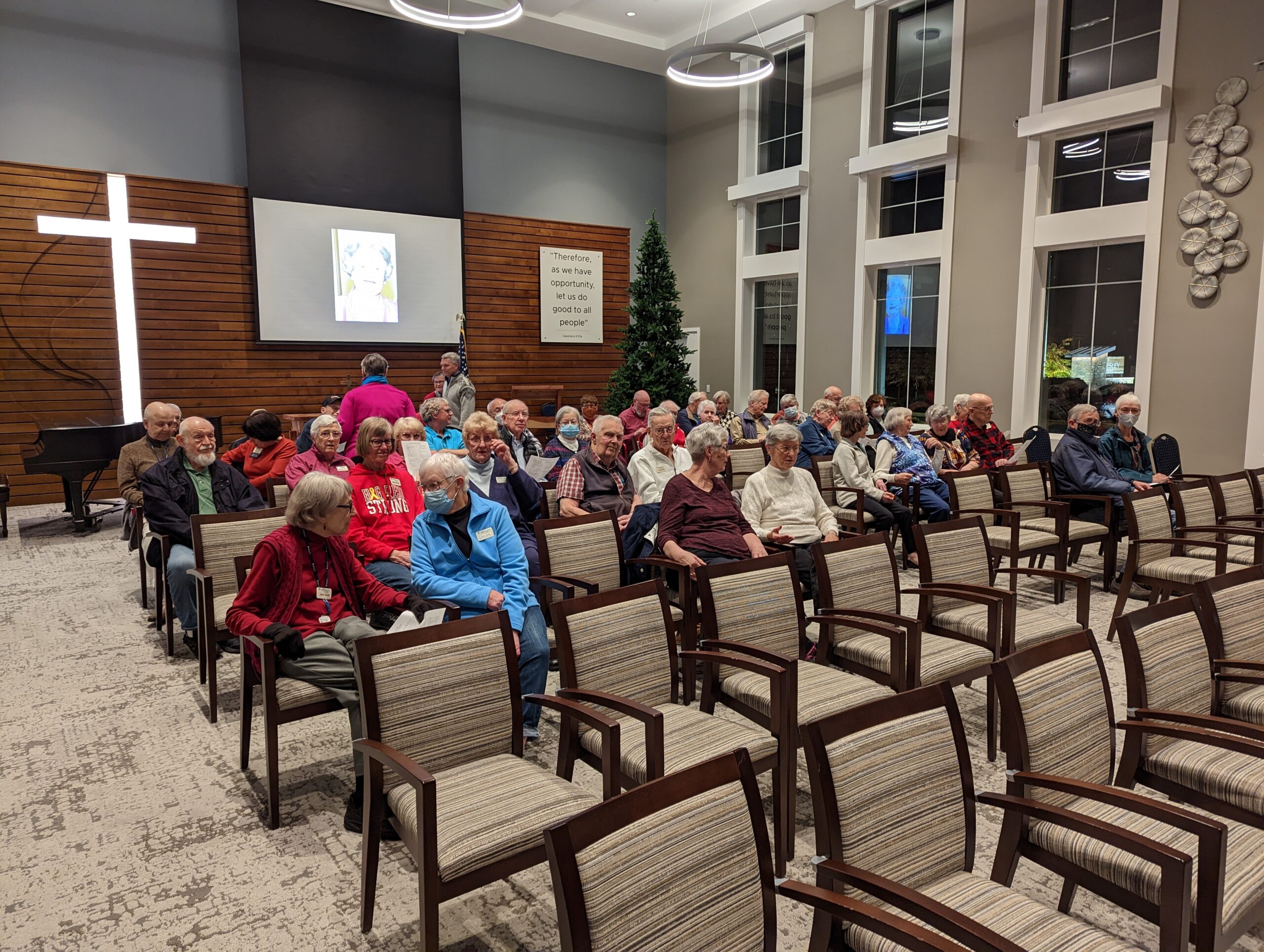 Room with people sitting in chairs