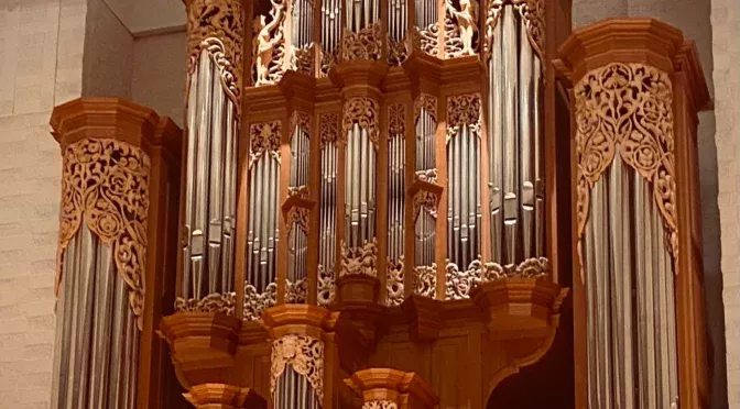 Four people standing in organ gallery