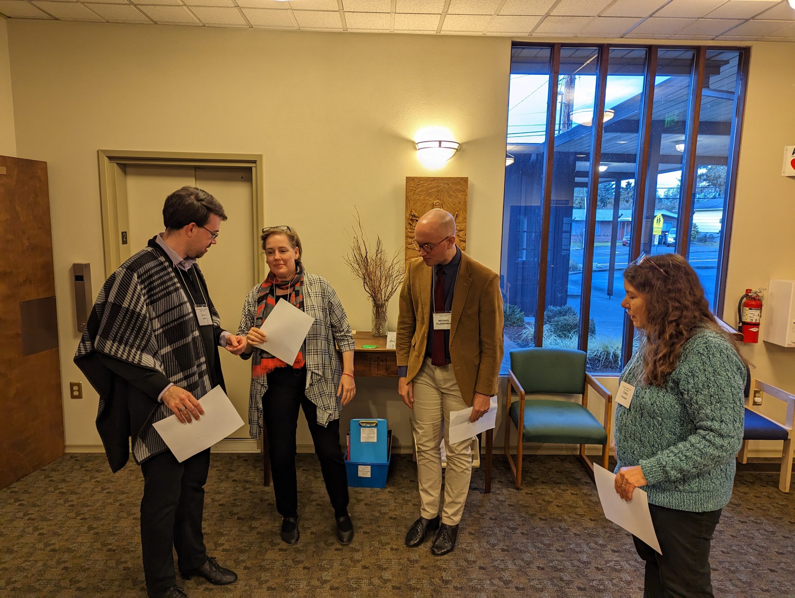 Group of 4 people standing in lobby
