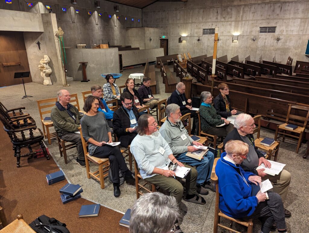 group of people sitting in chairs in a church