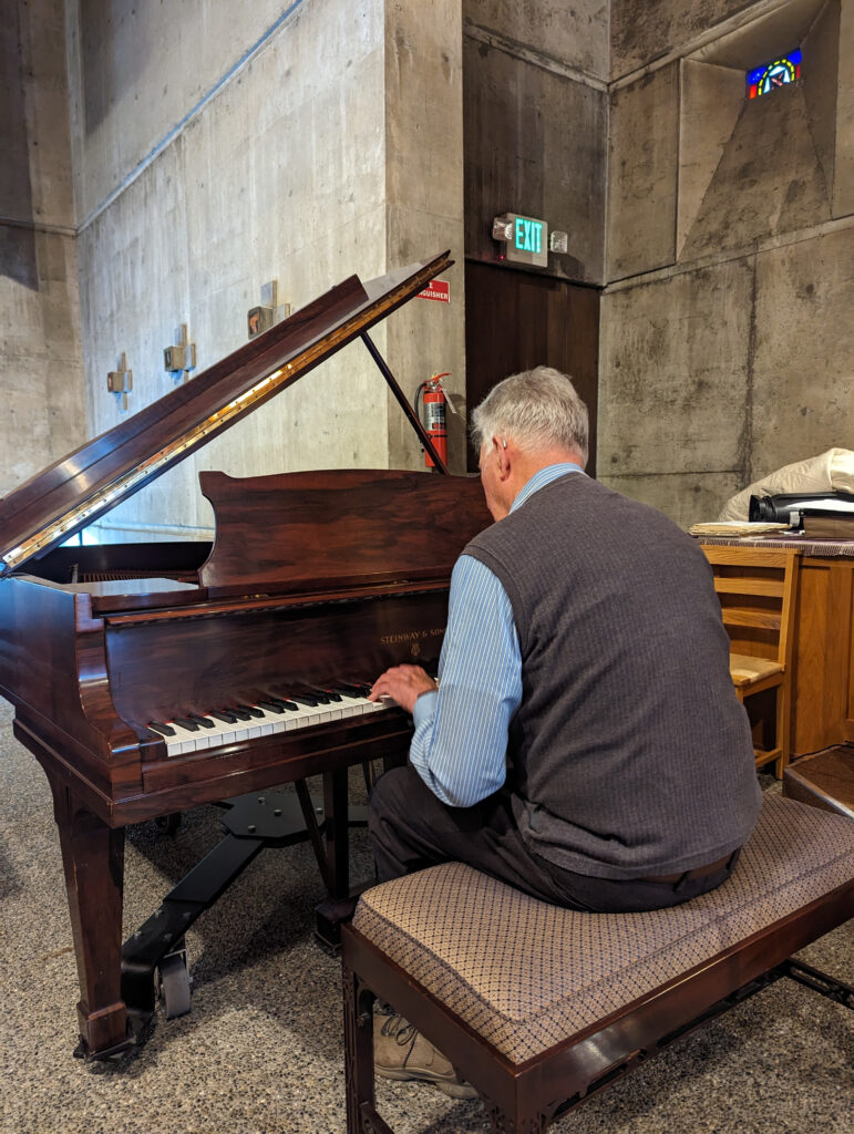 man playing grand piano