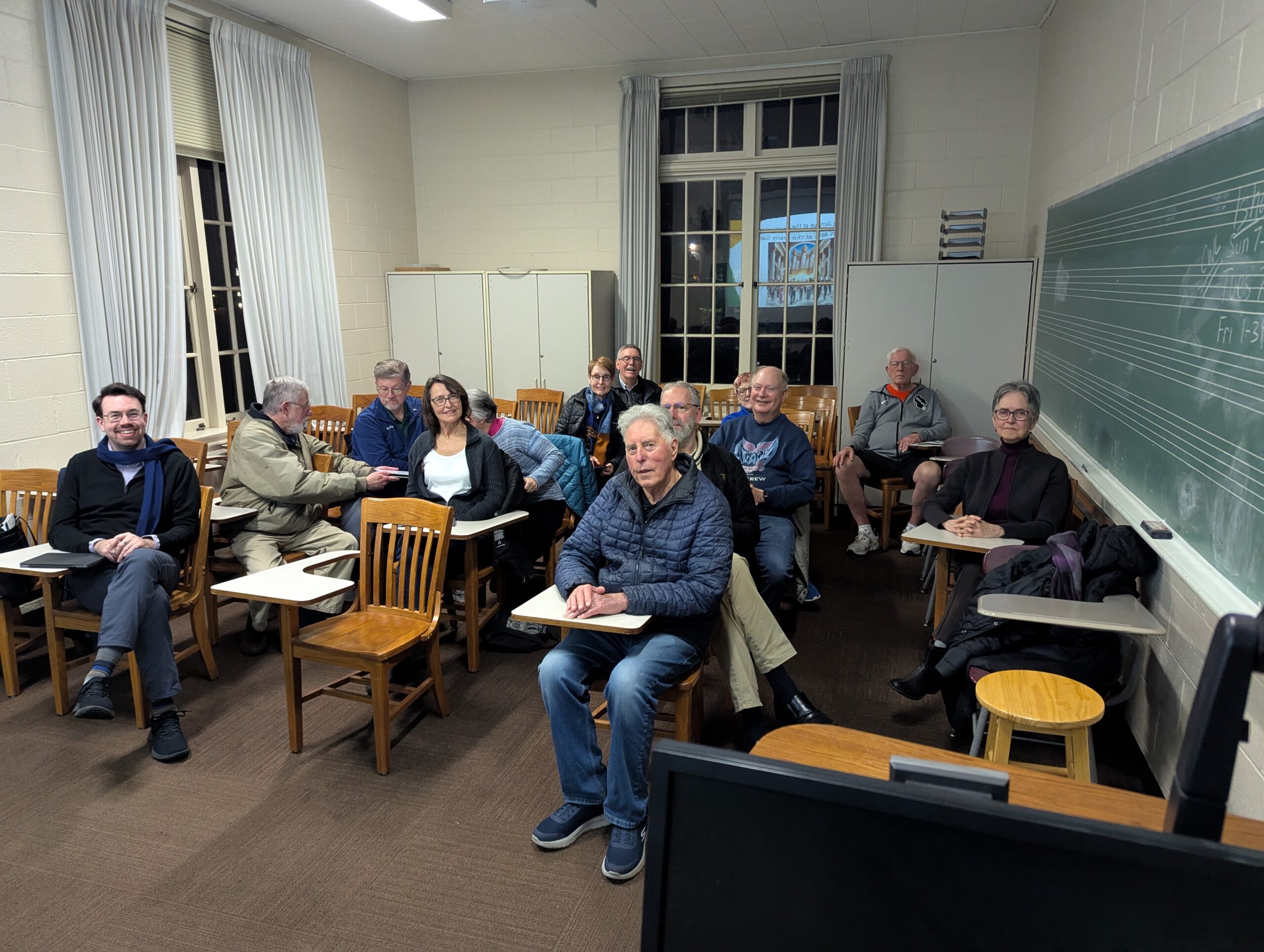 A classroom with people sitting at desks
