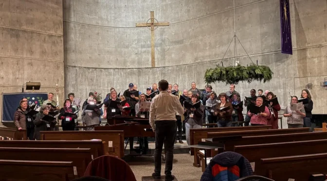 A choir stands at the front of a church.